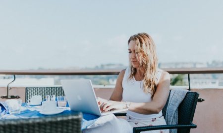 Businesswoman using laptop on a balcony to search what are pyramid charts