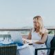 Businesswoman using laptop on a balcony to search what are pyramid charts