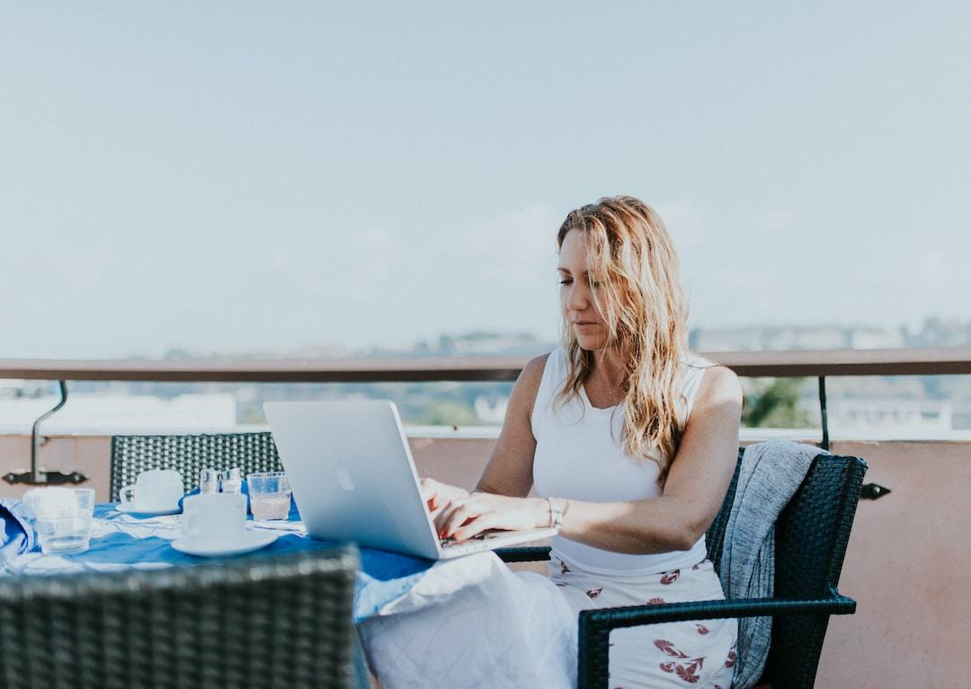 Businesswoman using laptop on a balcony to search what are pyramid charts