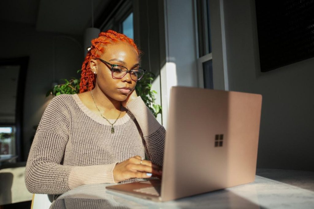 Entrepreneur using laptop and learning about what are pyramid charts best used for in terms of representing data